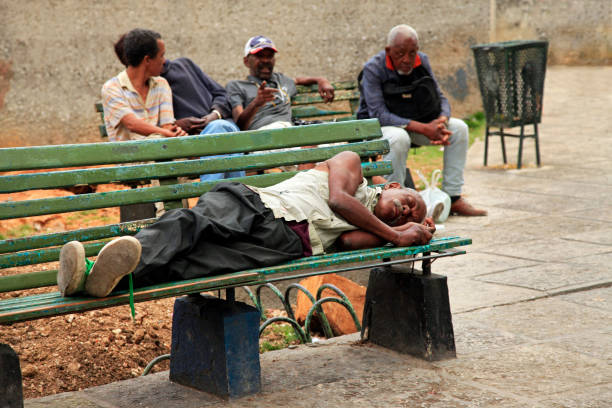 Havana, Cuba - January 10, 2019: Homeless man lying on a bench in old Havana, Cuba