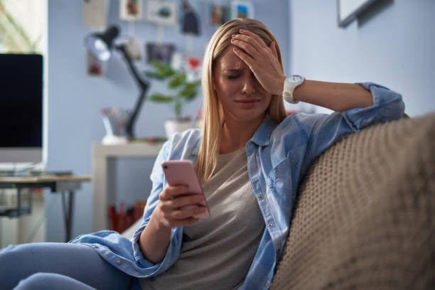 istock Young woman with cellphone feeling sad and unhappy 1130918845