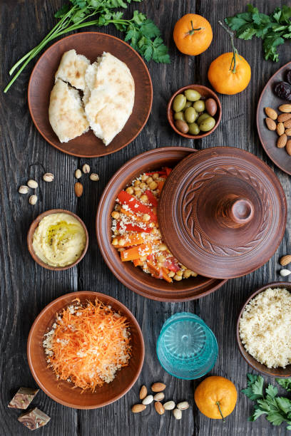 istock Moroccan traditional tajin and various snacks on dark wooden table 1130918966