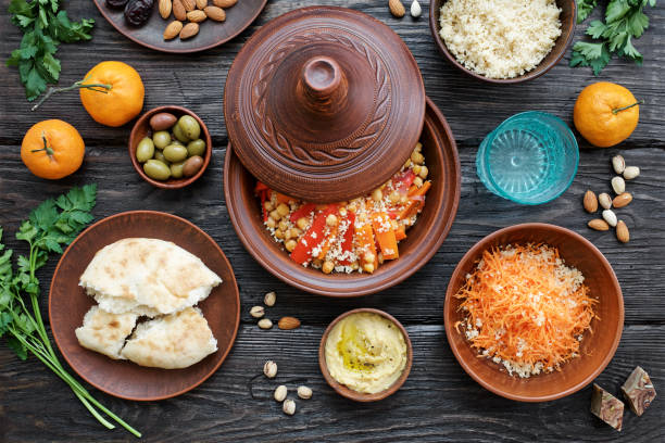 istock Moroccan traditional tajin and various snacks on dark wooden table 1130919175