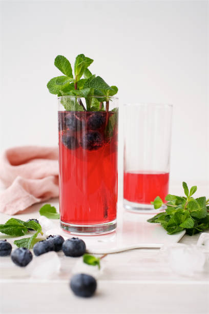istock Berry lemonade in glass cups on light background. Close up view 1130919232