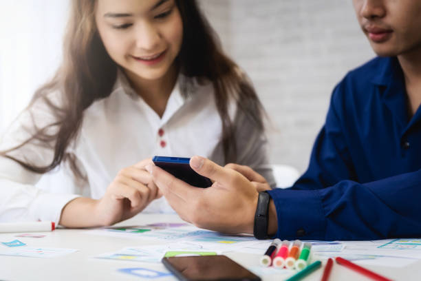 Group of people designers mobile application working wireframe sketch drawing application in office. Teamwork  user experience Design concept.