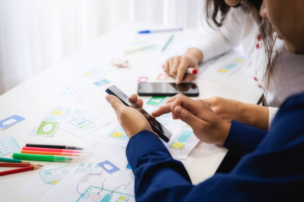 istock Group of people designers mobile application working wireframe sketch drawing application in office. Teamwork  user experience Design concept. 1130920706