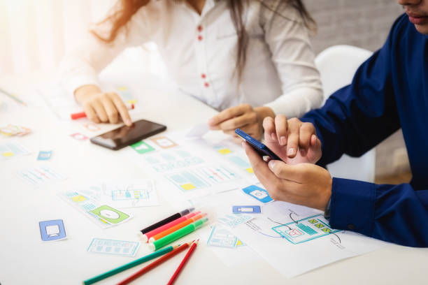 istock Teamwork of designers planning application for mobile phone. User experience Design concept. 1130921108