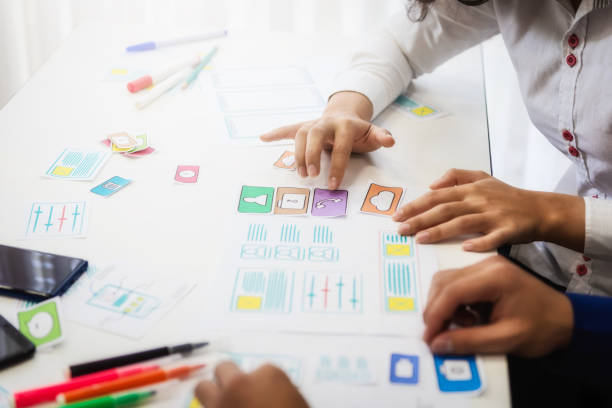 istock Designer creative graphic discussing sketch planning application mobile phone in office. User experience concept. 1130921175