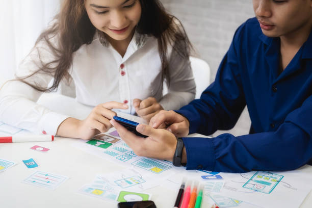 Group of people designers mobile application working wireframe sketch drawing application in office. Teamwork  user experience Design concept.