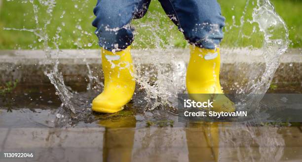 Toddler Jumping In Pool Of Water At The Summer Or Autumn Day Stock Photo - Download Image Now