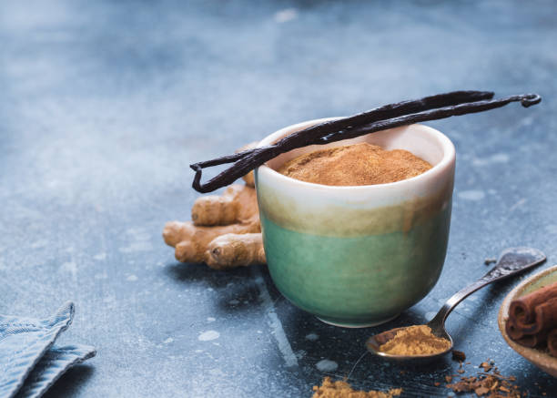 istock Delicious Vanilla Chai Tea Mix In Rustic Cup With Vanilla Pods 1130922468