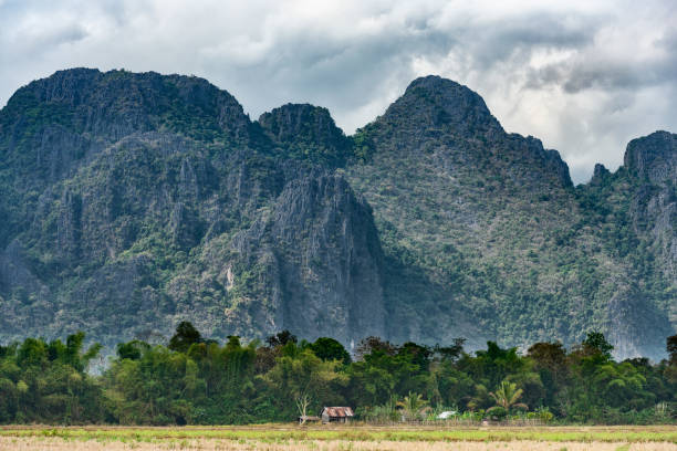 istock Stunning view of a some limestone mountains illuminated by some sun rays that filter through some clouds. Vang Vieng, Laos. 1130922816