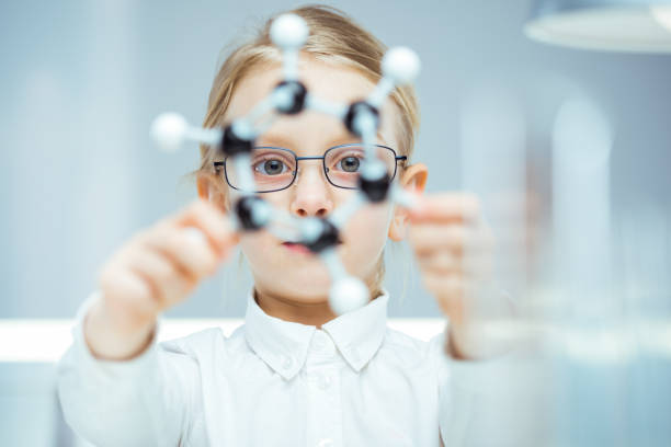 istock Portrait of a girl holding plastic molecule 1130923131