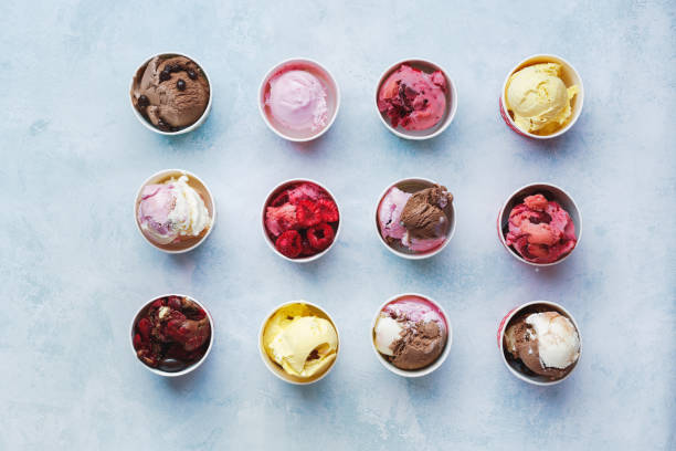 istock Scoops of fruit and chocolate ice cream in cups on rustic background 1130923669