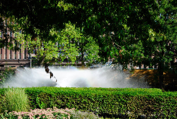 Outdoor air conditioning climate in hot weather. Street gate climate control in the waterpark. Aerosol spraying water jets, spraying cooling water. Air conditioning nozzle.