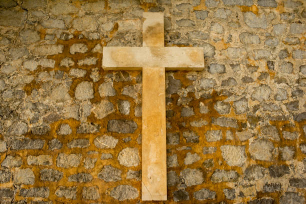 istock A Christian cross on a stone wall 1130925048