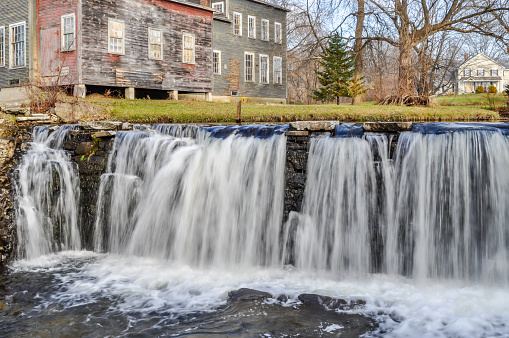 Water falls from a ledge of rock along the Otter Creek in Brandon, Vermont.