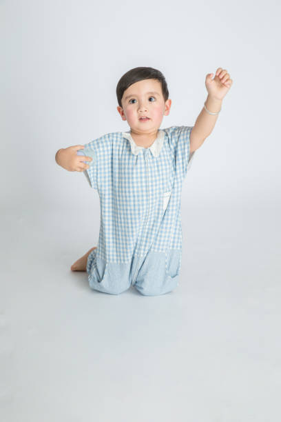 istock Smiling boy which kneels,on white background. 1130927939