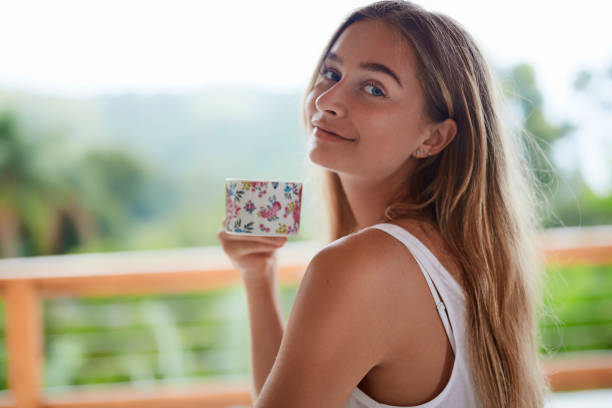 istock Smiling girl with teacup 1130928276