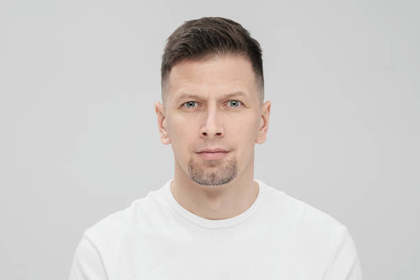 istock Futuristic handsome bearded brunet man 40s years in white clothes on a white background close-up. God, teacher and boss. 1130929186
