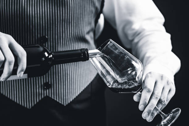 istock Midsection Of Bartendar Pouring Wine In Glass 1130929765
