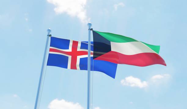 istock Kuwait and Iceland, two flags waving against blue sky 1130931686