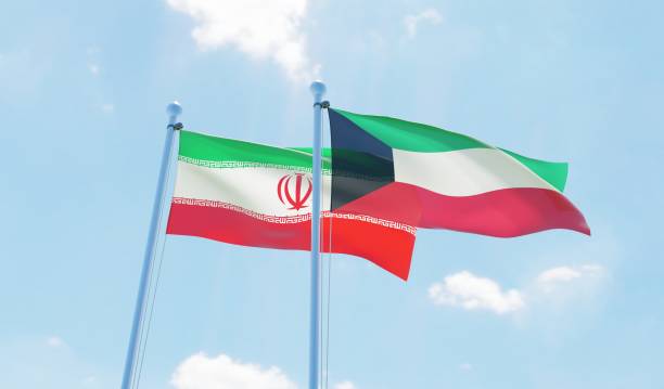 istock Kuwait and Iran, two flags waving against blue sky 1130931697