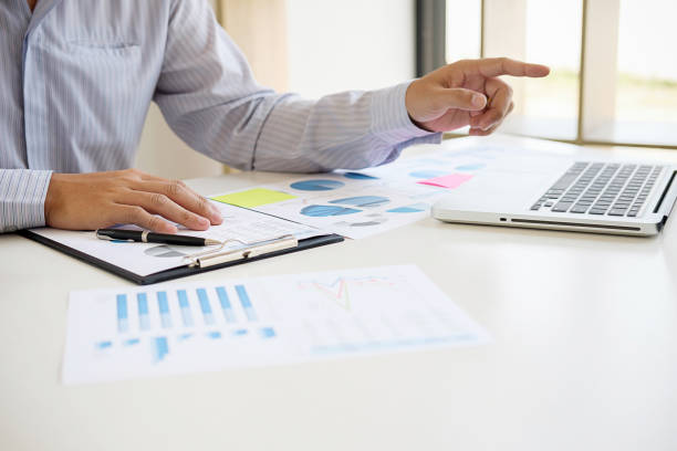 istock Business adviser analyzing financial figures denoting the progress Internal Revenue Service checking document. Audit concept 1130931936