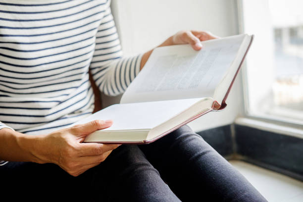 istock Woman is reading and praying over bible 1130931954
