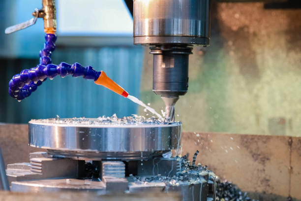 Drilling machine makes a hole in the metal product. Coolant is pouring on the drill. Drilling machine makes a hole in the metal product. Coolant is pouring on the drill. metal worker stock pictures, royalty-free photos & images