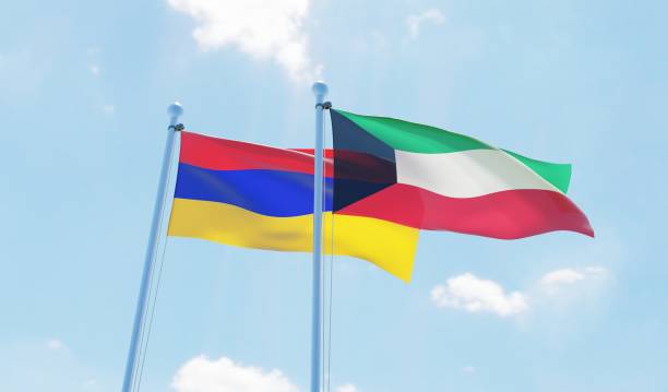 istock Kuwait and Armenia, two flags waving against blue sky 1130932338