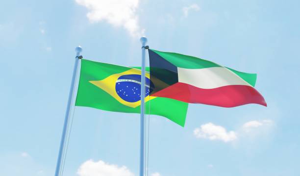 istock Kuwait and Brazil, two flags waving against blue sky 1130932386