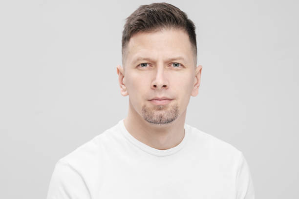 istock Futuristic handsome bearded brunet man 40s years in white clothes on a white background close-up. God, teacher and boss. 1130932409