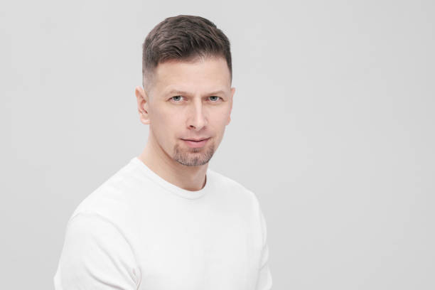 istock Futuristic handsome bearded brunet man 40s years in white clothes on a white background close-up. God, teacher and boss. 1130932414