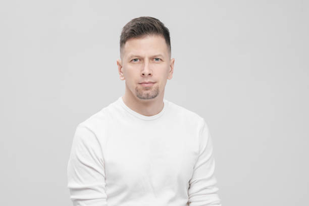 istock Futuristic handsome bearded brunet man 40s years in white clothes on a white background close-up. God, teacher and boss. 1130932433