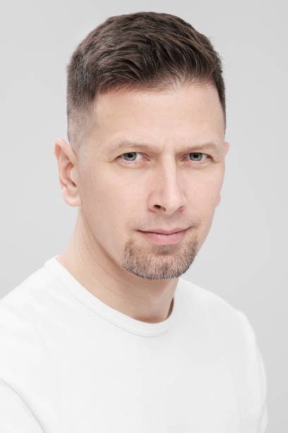 istock Futuristic handsome bearded brunet man 40s years in white clothes on a white background close-up. God, teacher and boss. 1130932499