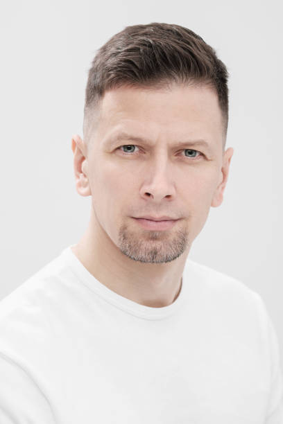 istock Futuristic handsome bearded brunet man 40s years in white clothes on a white background close-up. God, teacher and boss. 1130932504