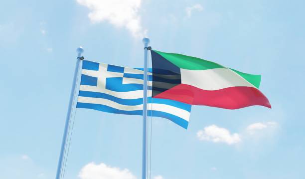 istock Kuwait and Greece, two flags waving against blue sky 1130932568