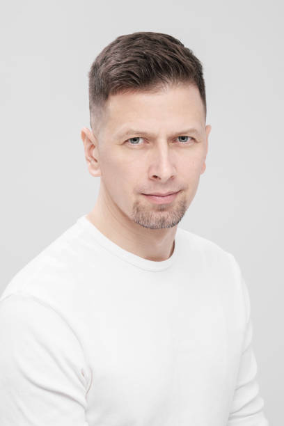 istock Futuristic handsome bearded brunet man 40s years in white clothes on a white background close-up. God, teacher and boss. 1130932594