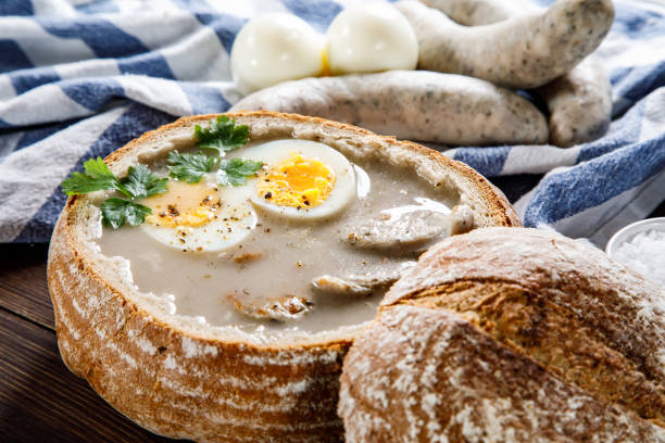 istock Sour rye soup in bread on wooden table 1130934034