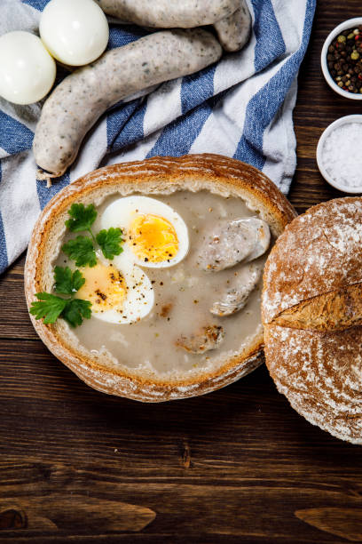 istock Sour rye soup in bread on wooden table 1130934083