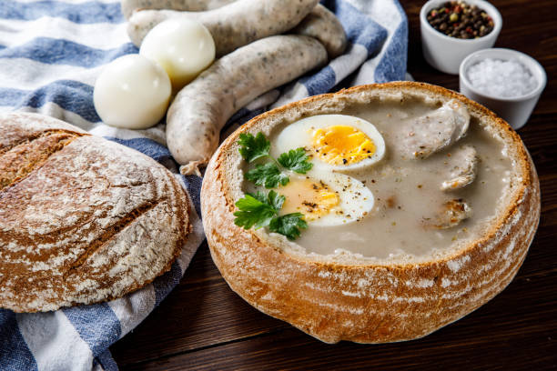 istock Sour rye soup in bread on wooden table 1130934365