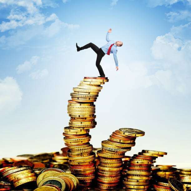 istock Digital Composite Image Of Businessman Standing Stacked Coins Against Sky 1130935446