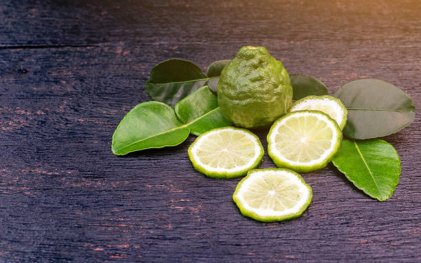 istock Fresh bergamot fruit and green leaf on wooden table background. Blank copy space 1130936273