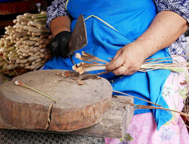 istock Cleaning and preparing lemongrass for sell. 1130936282