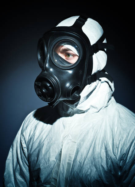 istock Man Wearing Gas Mask Against Black Background 1130939178