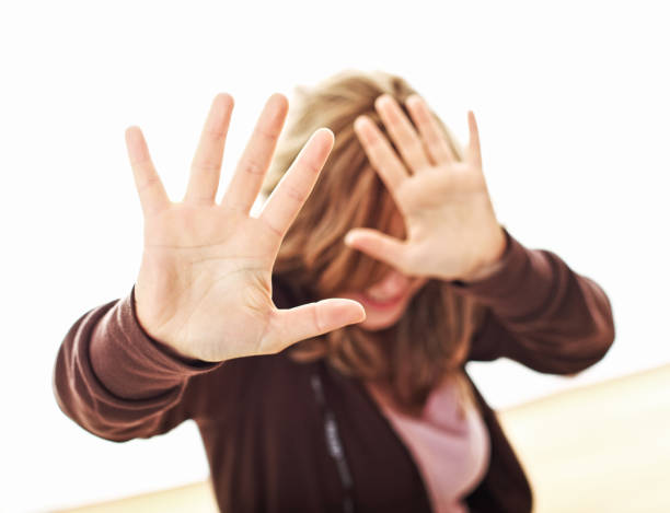 istock Woman Gesturing Stop Sign Against White Background 1130939182