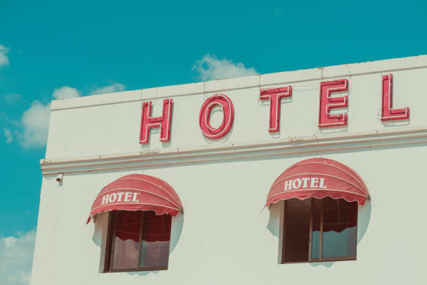 Old unclean hotel facade with vintage neon sign stock photo