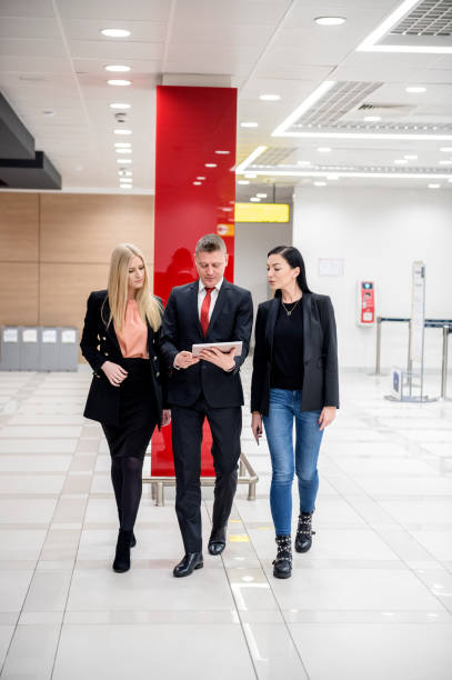 istock Manager and his beautiful assistants going to meeting 1130942903