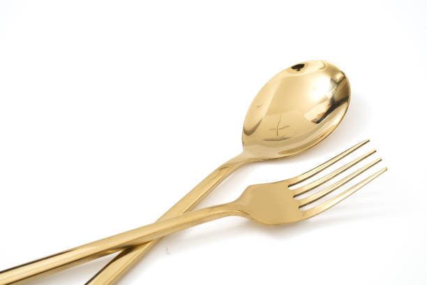 istock golden spoon and fork isolated on a white background 1130943125