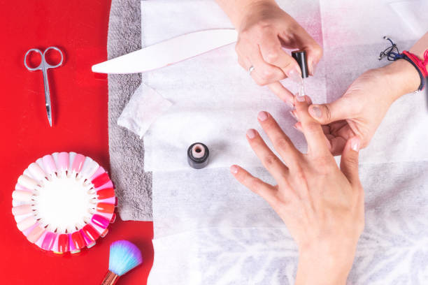 istock Professional manicurist worktable with working tools, applying nail polish in a woman nails salon. 1130943618