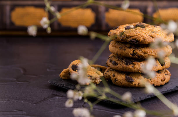 istock Chocolate cookies standing on a black slate stone dish. 1130944275
