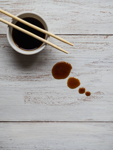 istock Chopsticks and soy sauce on white wooden table. 1130944392